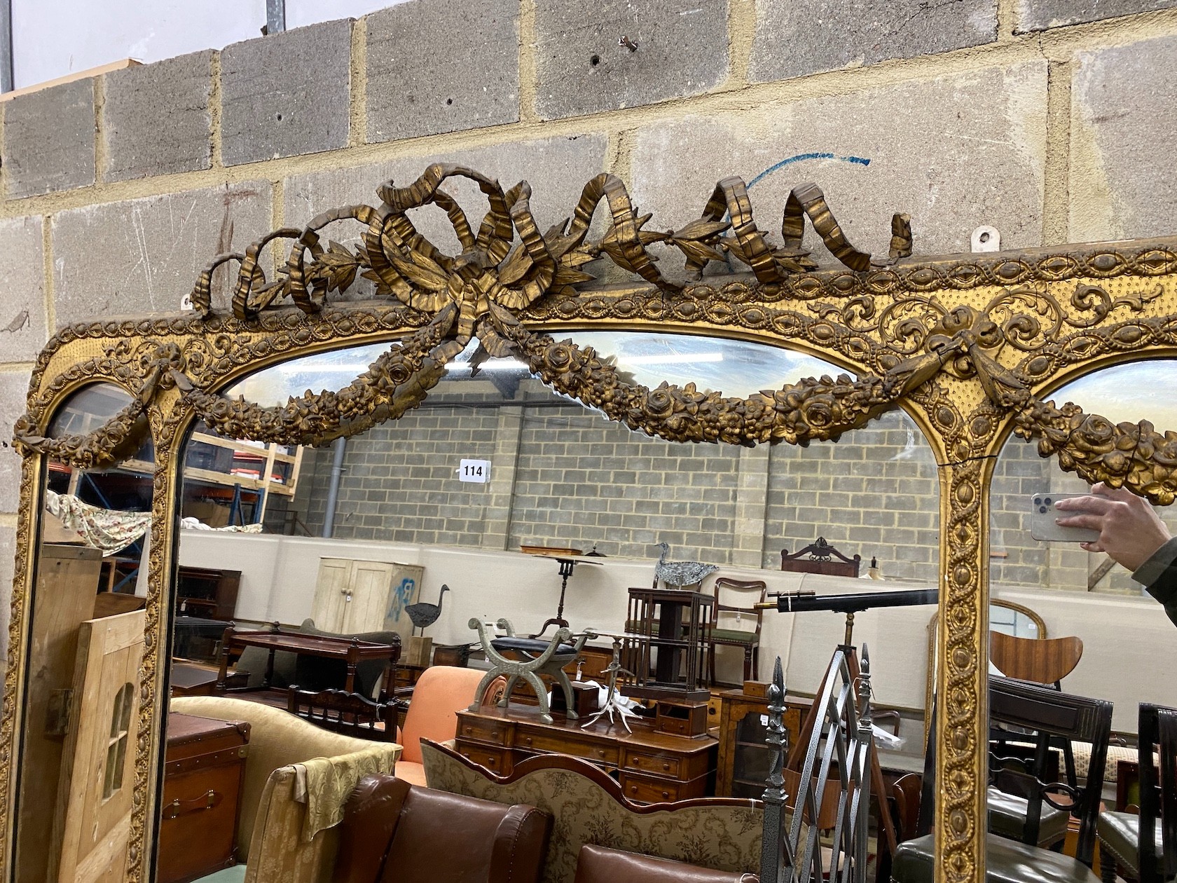 A Victorian giltwood and composition overmantel wall mirror with swagged ribbonfold surmount, width 148cm, height 199cm